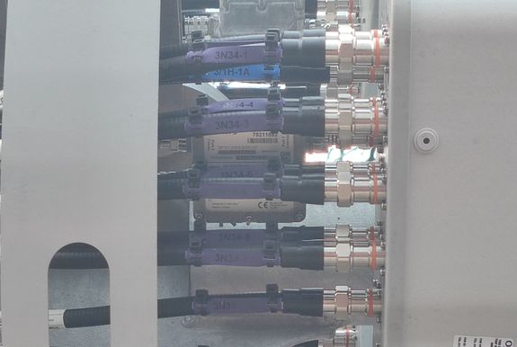 Image of Kathrein smart bias tee obscured by feeders into the passive antenna panel